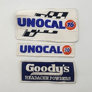 May include: Three rectangular embroidered patches. The top patch is white with a black checkered flag design and blue text reading UNOCAL 76. The middle patch is white with blue text reading UNOCAL 76. The bottom patch is blue with white text reading Goody's HEADACHE POWDERS.