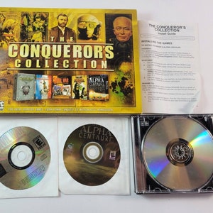 May include: A vintage PC game collection titled "The Conqueror's Collection" with multiple game covers and CDs. The box art features historical figures and game titles. Includes install guide and a CD case.