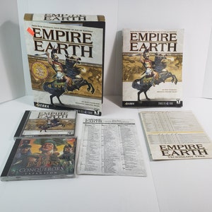 May include: A collection of the PC game "Empire Earth" including the game box, game case, and expansion pack. The box art features a warrior on horseback. Additional items include game manuals and a technology tree.