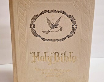 May include: A white Holy Bible with a gold embossed title and a dove with an olive branch design. The quote "What therefore God hath joined together, let not man put asunder." Matthew 19:6 is printed below the title.