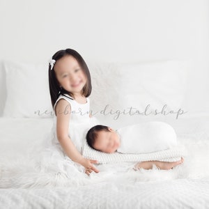May include: A young child in a white dress sits beside a swaddled newborn baby on a bed with white bedding and a fluffy white blanket. The image has a soft, bright aesthetic, with the text "newborn digital shop" in the background.