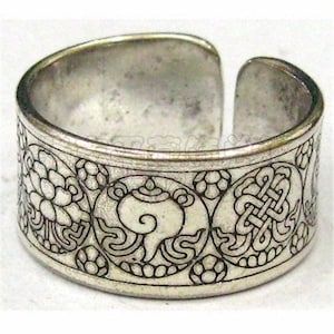 May include: Silver-toned adjustable ring with intricate etched patterns. The ring features floral and geometric designs, including a stylized knot and a swirling motif. The open design allows for size adjustment. The ring is approximately 1 inch wide.