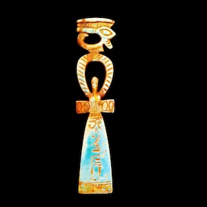 May include: A vertical decorative object featuring an ankh symbol combined with an eye motif at the top. The piece is colored in shades of light blue, tan, and brown, with etched hieroglyphic-style markings visible on the lower flared section.