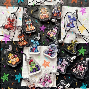 May include: A collection of 17 colorful character charms featuring characters from the popular video game franchise Five Nights at Freddy's. The charms are made of clear acrylic and feature a variety of characters, including Freddy Fazbear, Bonnie the Bunny, Chica the Chicken, Foxy the Pirate Fox, and more. The charms are attached to black strings and are perfect for adding a touch of fun to your keys, bags, or phone.