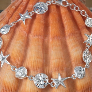 Zilveren Sea Life-armband. 7 1/2&quot;, diamantgeslepen .925 sterling zanddollar, zeester, coquille schakelarmband, kreeftenklauw, snelle gratis verzending