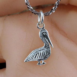 Silver Pelican pendant. 11/16&quot; tall + 1/4&quot; bail Diamond cut .925 Sterling, pelican charm sitting. Fast free shipping