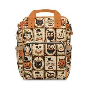 May include: A backpack featuring a repeating grid pattern of vintage-style Halloween illustrations, including skulls, black cats, owls, ghosts, pumpkins, and devils in orange, black, and cream colors, with orange top handles and a front zipper pocket.