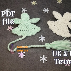 May include: Two crocheted angel ornaments with a green and white color scheme. The ornaments have a tassel attached to the bottom and are on a gray background with snowflake confetti. The text "PDF file" and "UK & US Terms" are also visible in the image.