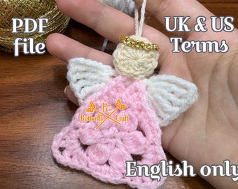 May include: A handmade crochet angel ornament with a cream-colored head and white wings. The angel's dress is pink, and it has a gold halo. The image also includes the text "PDF file", "UK & US Terms", and "English only".
