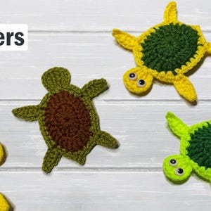 May include: Four handmade crochet turtle shapes in yellow, green, and brown, with the words "Beginners" and "Slow" in the upper left corner. The turtles have a green shell and yellow or green limbs and heads.
