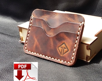 May include: A handcrafted brown leather cardholder with three card slots and a stitched border. The cardholder features a logo and is displayed next to a small wooden box. The leather has a distressed finish.