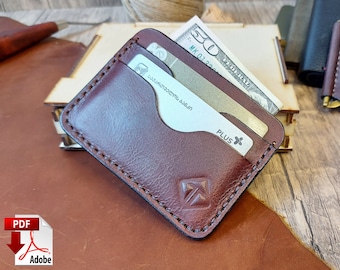 May include: A brown leather wallet with a stitched edge and a small arrow logo. The wallet has two card slots and a cash pocket. The wallet is lying on a brown wooden surface.
