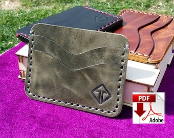 May include: A collection of handmade leather cardholders in various colors, including olive green, black, and brown. Each wallet features a unique design, with visible stitching and a logo. The wallets are displayed on a purple surface.