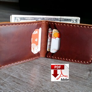 May include: Open brown leather wallet with visible card slots and a five-dollar bill. The wallet is hand-stitched with a contrasting thread. The image includes a PDF Adobe icon in the bottom right corner.