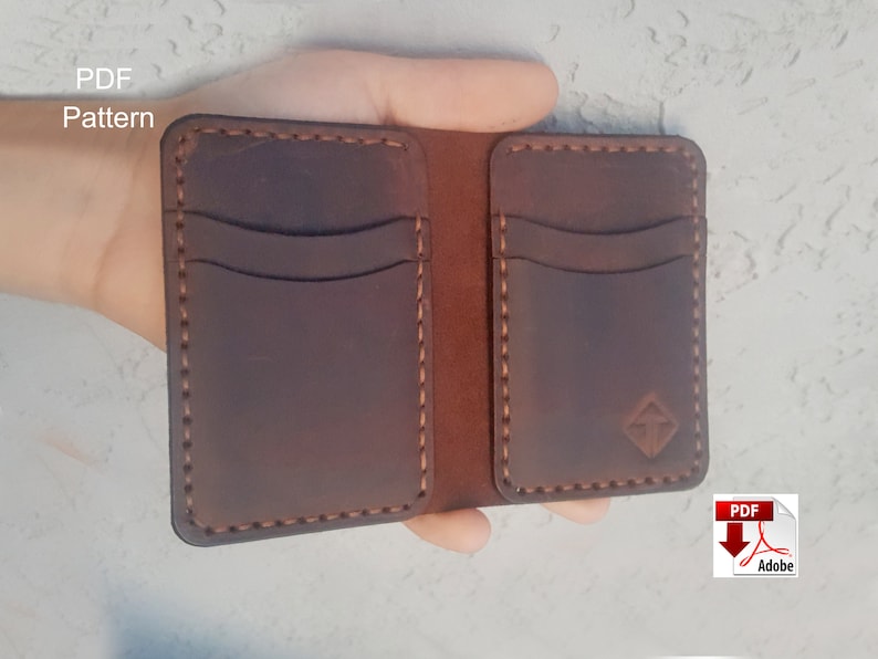 May include: A brown leather wallet with multiple card slots and a stitched design. The wallet is open and held in a hand. The text "PDF Pattern" is visible in the top left corner of the image.