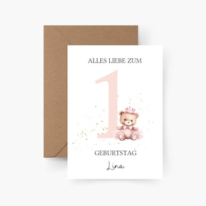 May include: A white greeting card with a pink number one and a teddy bear wearing a crown. The card has the text "ALLES LIEBE ZUM GEBURTSTAG Lina" and is paired with a brown envelope. Gold glitter accents the design.