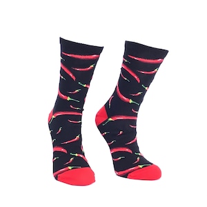 May include: A pair of black socks with a red chilli pepper pattern. The socks are made of a soft, comfortable material and are perfect for everyday wear.