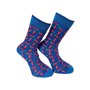 May include: A pair of blue socks patterned with red chilli peppers and green stems. The socks have a blue cuff, heel, and toe. The socks are shown against a white background.