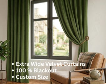 May include: Extra wide olive green velvet curtains with 100% blackout functionality and custom size options. The curtains hang from a silver rod, with one panel held back by a gold lion-head tieback, framing a dark-framed window.