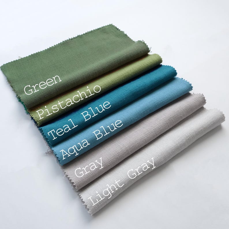 May include: A stack of fabric swatches in various shades of green, blue, and grey. The swatches are labelled with the colours: Green, Pistachio, Teal Blue, Aqua Blue, Grey, and Light Grey.