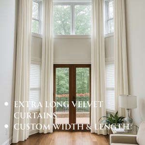 May include: Extra long cream-coloured velvet curtains hanging from the ceiling to the floor, framing a set of double glass doors and windows. The text on the image reads: EXTRA LONG VELVET CURTAINS, CUSTOM WIDTH & LENGTH.