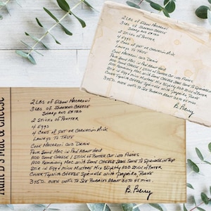 May include: Two wooden recipe cards with handwritten text. One card reads "Aunt B's Mac & Cheese" and lists ingredients and instructions. The other card is a separate recipe with similar content. Both cards are aged.