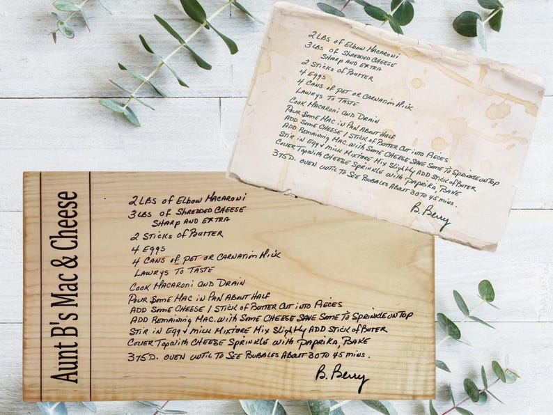 May include: Two wooden recipe cards with handwritten text. One card reads "Aunt B's Mac & Cheese" and lists ingredients and instructions. The other card is a separate recipe with similar content. Both cards are aged.
