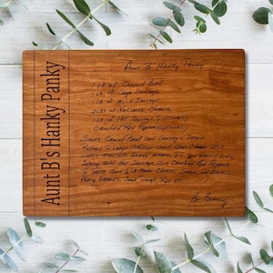 May include: A rectangular wooden cutting board with the text "Aunt B's Hanky Panky" engraved on the side. The board features a handwritten recipe for "Aunt B's Hanky Panky" with ingredients and instructions.