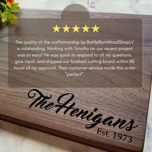 May include: A rectangular wooden cutting board with a dark finish. The board is engraved with "The Henigans" and "Est. 1973". The image also includes text about the quality of the craftsmanship.