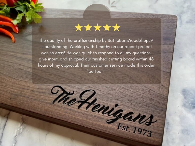 May include: A rectangular wooden cutting board with a dark finish. The board is engraved with "The Henigans" and "Est. 1973". The image also includes text about the quality of the craftsmanship.