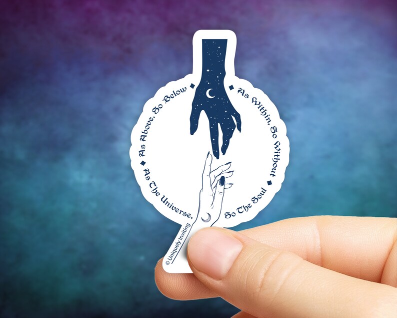 May include: A white sticker with a celestial design featuring two hands reaching towards each other. The top hand is filled with stars and a crescent moon. Text around the design reads "As Above, So Below" and "As Within, So Without."