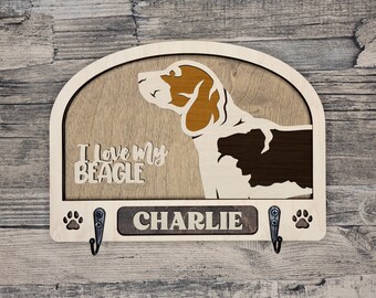 May include: Wooden key holder with a beagle silhouette, the text "I love my Beagle" and the name "Charlie" on a brown plaque. Two hooks are attached to the bottom.