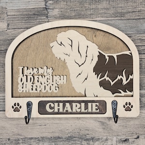May include: Wooden key holder featuring a silhouette of an Old English Sheepdog and the text "I love my Old English Sheepdog". The name "CHARLIE" is engraved on the bottom of the holder.