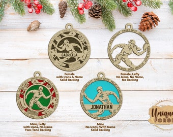 May include: Four different wooden disc ornaments with a disc golf theme. Each ornament features a disc golfer throwing a disc. The ornaments are personalized with names, "Gabriella" and "Jonathan". The ornaments have different color backgrounds and some have additional disc golf icons.
