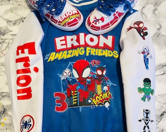 May include: A blue and white letterman jacket and matching sneakers featuring Spider-Man graphics. The jacket has the name "Erion" in red on the sleeve and "Erion and his Amazing Friends" on the front. The sneakers have blue laces and Spider-Man designs.