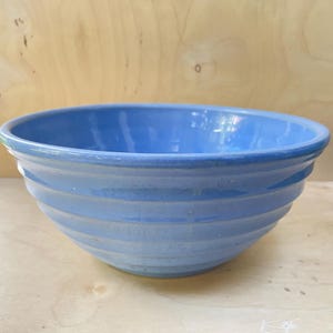 May include: A trio of ceramic mugs with a speckled, matte finish in cream, light grey, and dark grey. Each mug features a simple, minimalist design, ideal for tea or coffee.