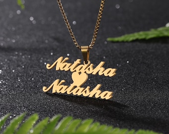 May include: Gold necklace with a pendant featuring the name "Natasha" twice, with a heart symbol between the names.