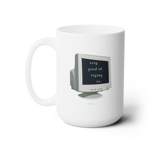 May include: White ceramic mug featuring a black and white illustration of a computer monitor displaying the text "very good at crying XO".