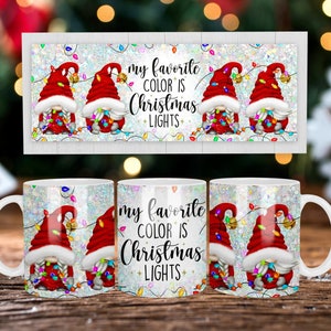 May include: White ceramic mug featuring a festive design with gnomes wearing red hats and holding Christmas lights. The text "my favorite color is Christmas lights" is also displayed. The mug has a white handle and a glittery background.