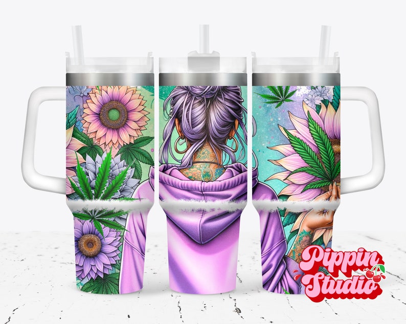 May include: A stainless steel tumbler with a purple and green floral design featuring a woman with a purple bun and tattoos. The tumbler has a white lid and a white handle. The text "Pippin Studio" is visible in the bottom right corner.