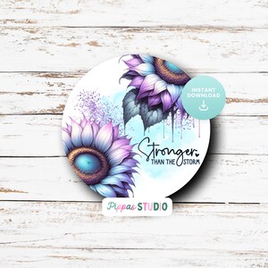 May include: A round digital art print featuring two purple and blue sunflowers with a white background. The text "Stronger Than The Storm" is written in black below the sunflowers.