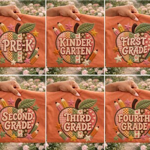 May include: A collection of six orange fabric pouches, each featuring an embroidered apple design with a patchwork pattern. The apples are decorated with pencils and stars, and each displays a different grade level: PRE-K, KINDERGARTEN, FIRST GRADE, SECOND GRADE, THIRD GRADE, and FOURTH GRADE.