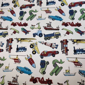 May include: A white background with a repeating pattern of various toy vehicles, including airplanes, helicopters, cars, trucks, rockets, and a scooter. The vehicles are in various colors, including red, blue, green, yellow, and black.