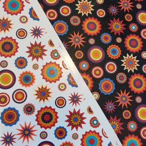 Könnte beinhalten: Zwei Blätter Geschenkpapier mit einem sich wiederholenden Muster aus bunten Kreisen und Sternen. Das Papier links hat einen weißen Hintergrund und das Papier rechts einen schwarzen Hintergrund.