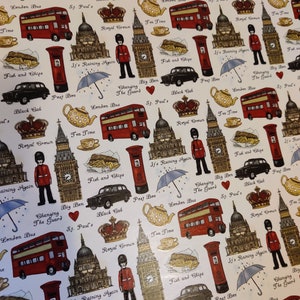 May include: A white background with a repeating pattern of London themed illustrations. The illustrations include a red double-decker bus, a black cab, Big Ben, a red post box, a royal crown, a teapot, a plate of fish and chips, and an umbrella. The text "It's Raining Again" appears multiple times.