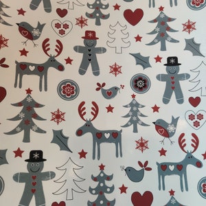May include: White wrapping paper with a repeating pattern of red, grey, and white Christmas-themed illustrations. The illustrations include reindeer, gingerbread people, birds, snowflakes, stars, and Christmas trees.