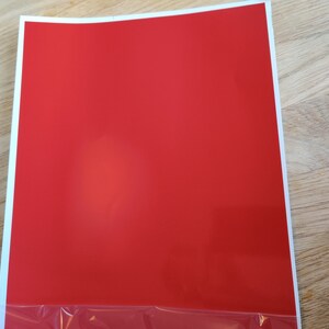 May include: A solid red sheet of paper.