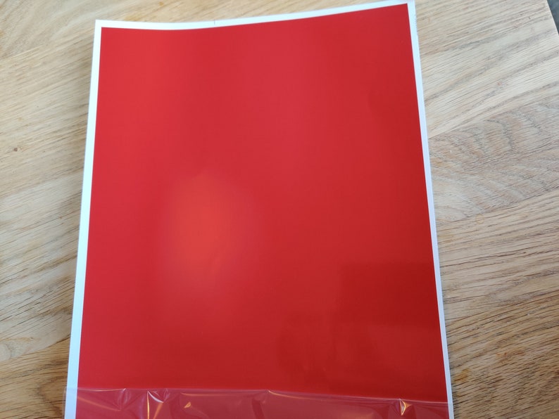 May include: A solid red sheet of paper.