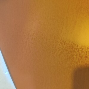May include: A close-up of a textured, metallic gold surface.