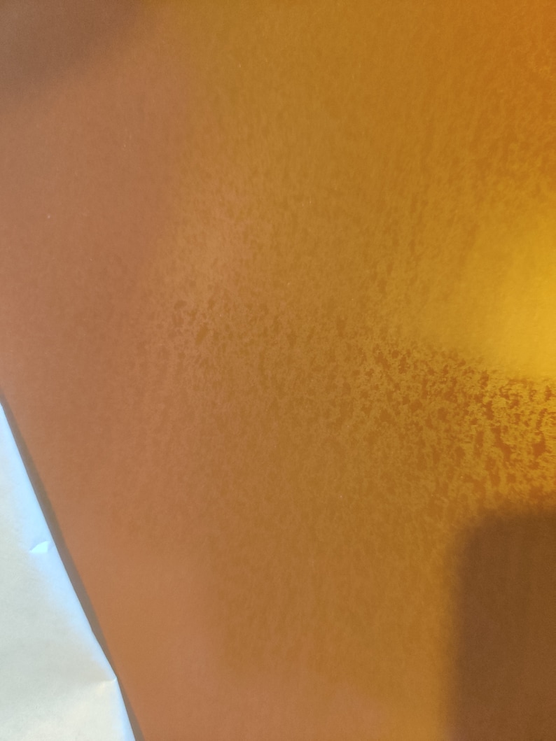May include: A close-up of a textured, metallic gold surface.